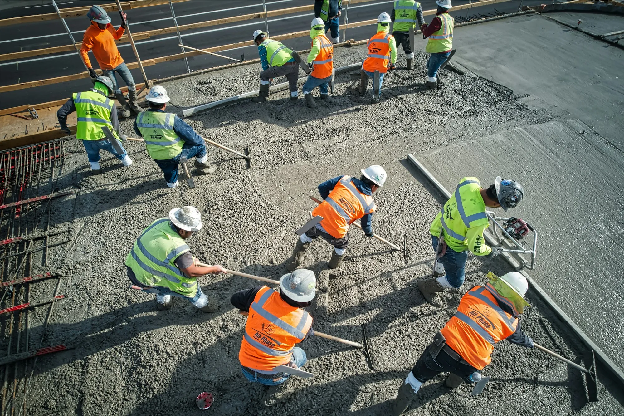 Overhead view of a crew spreading and leveling a concrete pour